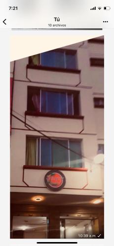 a building with windows and a sign on it at Hostal SAMARY in Atacames
