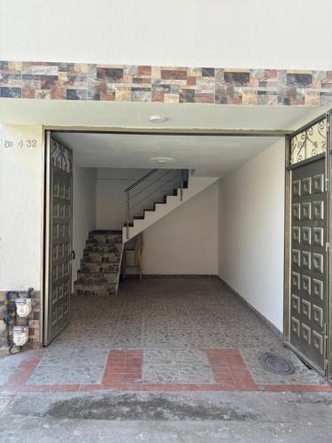 an open garage with a staircase in a building at ApartahotelVacacionalSangil in San Gil