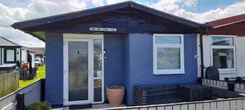 a blue house with a door and a window at Once Upon a Tide - Bridlington Chalet in Bessingby