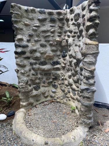 a close up of a stone boot on a plant at Jungle AC Suite for 3-Kitchen-Walk to Playa Chiquita -Villa Toronto in Cocles