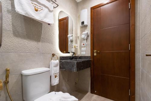 a bathroom with a toilet and a sink at Golden palm sunrise inn in Cairo