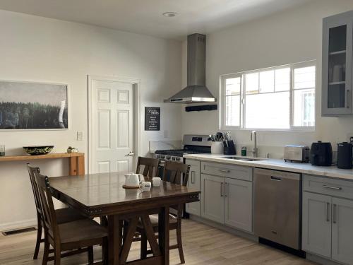 a kitchen with a table and chairs and a kitchen with a sink at Green House in Los Angeles