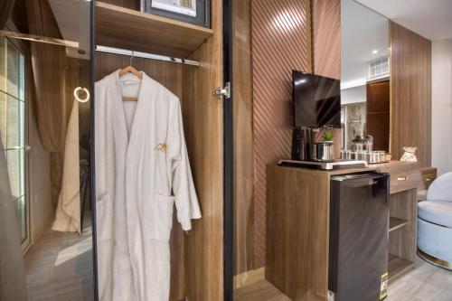 a robe hanging on a door in a bathroom at Golden palm sunrise inn in Cairo