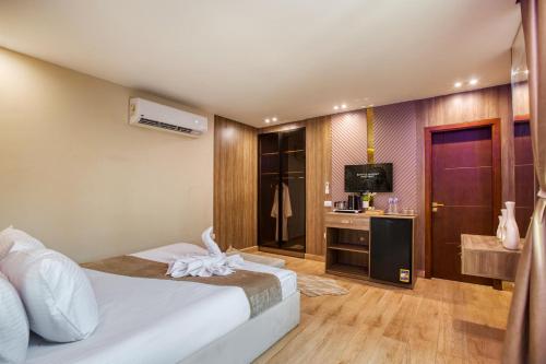 a hotel room with a bed and a television at Golden palm sunrise inn in Cairo