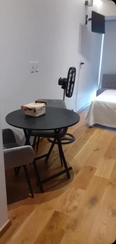 a table and chairs in a room with a bed at Mexico City loft in the heart of Roma Norte steps away from Cibeles in Mexico City