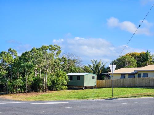 a house on the side of a road next to a street at Little Bitty in Cooktown
