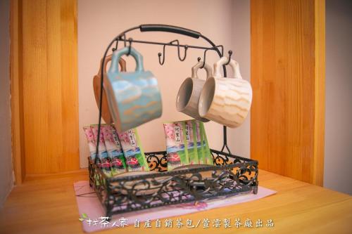 a kitchen rack with pots and pans on a table at Alishan Hinoki B&B in Leye