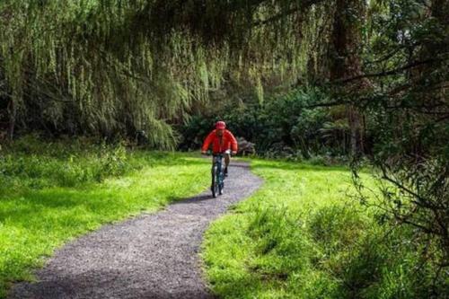 a person riding a bike down a trail at The Fantail Couples Retreat in Kinloch