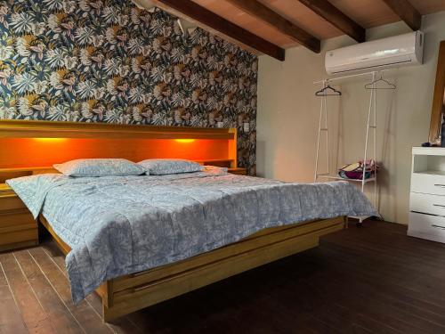 a bedroom with a bed with a blue comforter at San Bernardino para una pareja in San Bernardino
