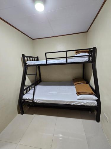 two bunk beds in a small room with a ceiling at 3BR - 4BR Family Transient in Baguio