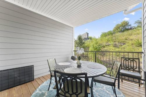 a patio with a table and chairs on a balcony at Branson Seasons Luxury Condo Pets Pool Grill Game Room Balcony in Branson