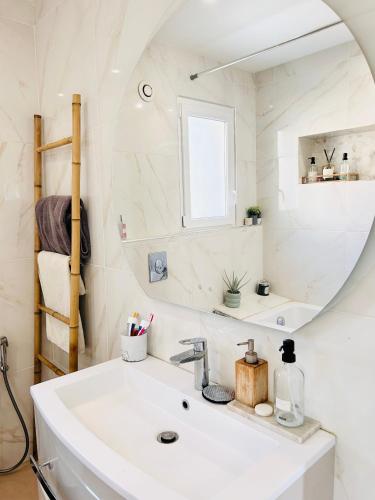 une salle de bain avec un lavabo et un miroir dans l'établissement Villa moderne avec piscine Bali et jacuzzi, à Toulon