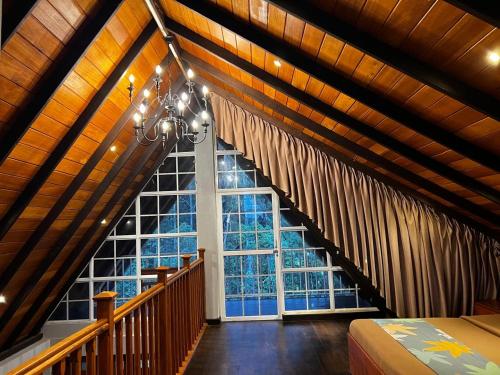 a bedroom with a large window and a bed in a room at Cabin 7000 feet Nuwaraeliya in Nuwara Eliya