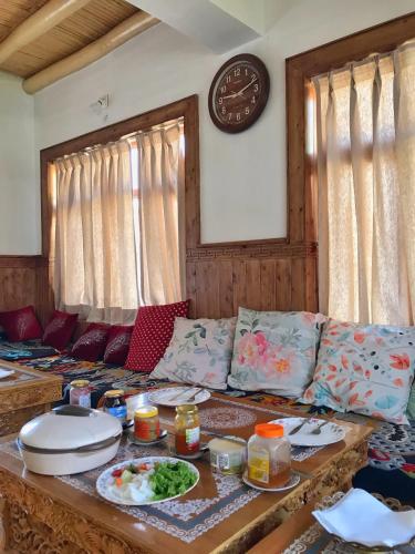 a living room with a couch with food on it at Sponbo Guest House, Leh in Leh
