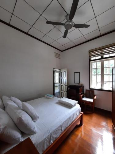 a bedroom with a bed and a ceiling fan at Hickory Penang Hill in George Town
