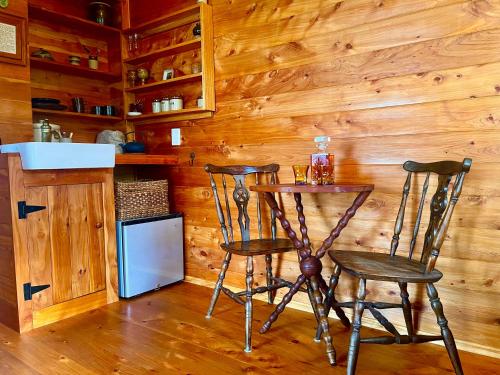 a small table and two chairs in a kitchen at Cape Foulwind Clifftop Cabin in Cape Foulwind