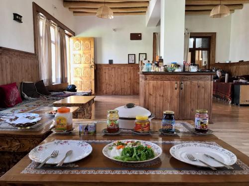 a living room with plates of food on a table at Sponbo Guest House, Leh in Leh