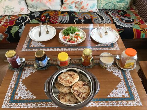 a table with food and plates of food on it at Sponbo Guest House, Leh in Leh