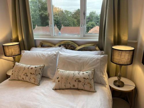 a bedroom with a bed with pillows and a window at Abbey view in Selby