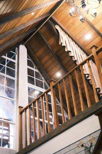 a wooden staircase in a room with windows at Cabin 7000 feet Nuwaraeliya in Nuwara Eliya