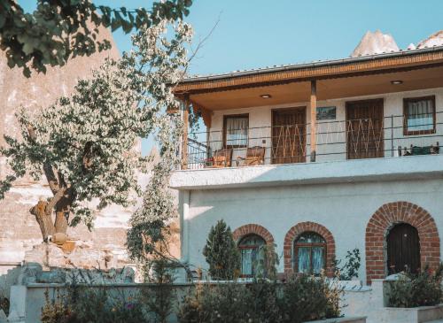 a house with a balcony on top of it at Turan Cappadocia Cave in Goreme