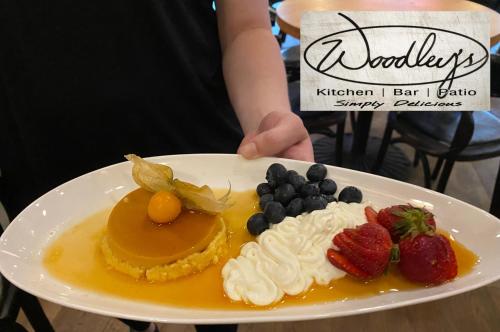 a plate of food with whipped cream and fruit on it at Harbour House Hotel in Ganges