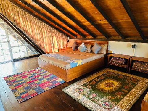 a bedroom with a bed and a rug in a room at Cabin 7000 feet Nuwaraeliya in Nuwara Eliya