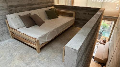 a bed in a room with a bench next to it at Sich - Casa Macu Saladita surf break in La Salada
