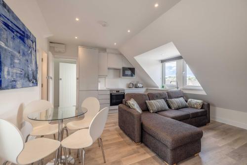 a living room with a couch and a table at ENTR - Modern Apartments in Windsor in Windsor