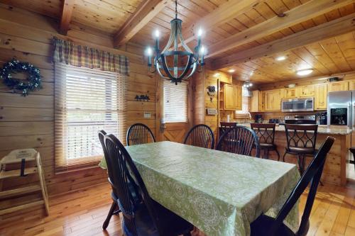 a dining room with a table and chairs in a cabin at Bear Climbing Getaway in Pigeon Forge