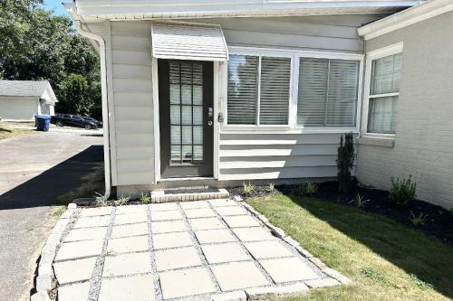 a white house with a door and a grass yard at South Perry St in Lawrenceville