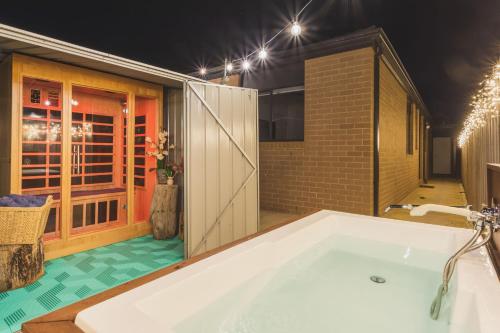 a large bathroom with a tub in a room at Sauna, King Beds, Tranquility Base Fun Large Home in Saint Leonards