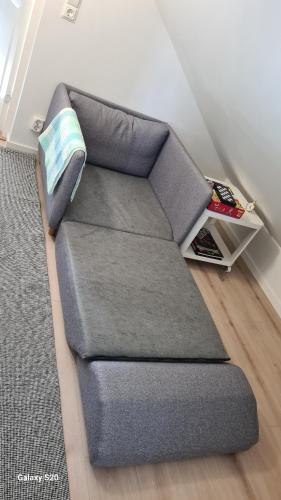 a grey couch in a living room with a rug at Welcome to our new build house! in Landvetter