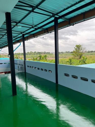a view of a body of water with columns and a building at กุลทีปโฮสเทล in Pathum Thani
