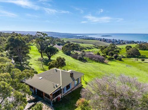 an aerial view of a house in a field at Rustic Cottage in Waitpinga