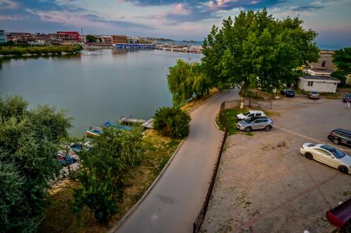 an aerial view of a parking lot next to a river at Complex Hotelier Corsa in Costinesti