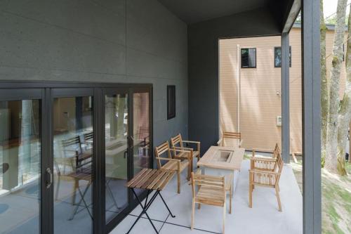 a patio with chairs and a table on a house at DAHARA s-2 in Minami Aso