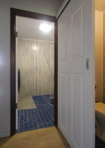 a bathroom with a shower and a toilet and a door at Cherswood Farm in Balbarrup