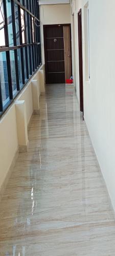 an empty hallway of a building with a door at Hotel Royal Blue in Coimbatore