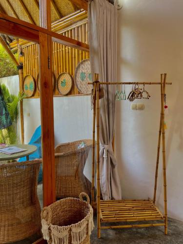 a room with a porch with a swing and a table at Sea Breeze Villas - Gili Air, Lombok in Gili Air