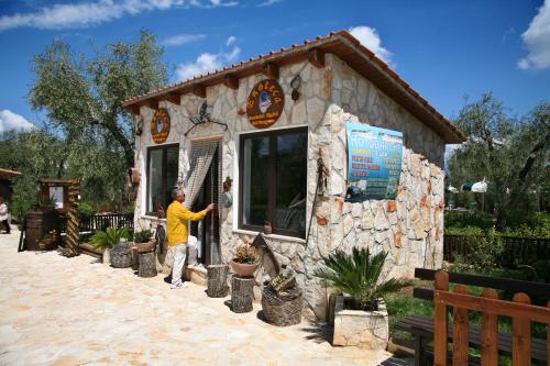 a man is standing outside of a small building at Tenuta Padre Pio in Vieste