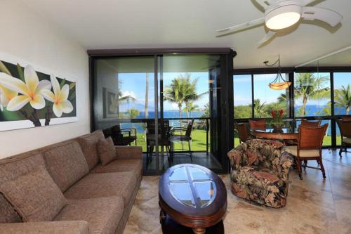 a living room with a couch and a table at Kihei Surfside, #511 condo in Wailea