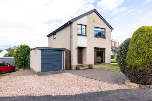 a house with a garage in front of it at 20 mins to Edinburgh 3 bedroom detached family house Wi-Fi Parking in Fife