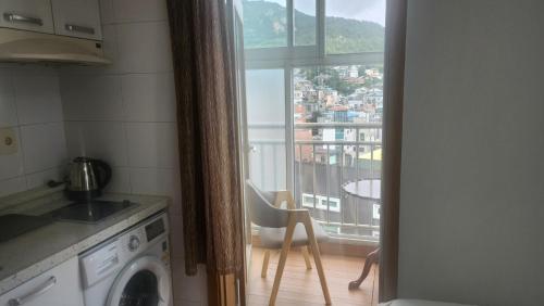 a kitchen with a window with a view of a city at Kiman09 in Seoul