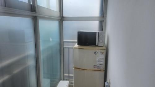 a television on top of a refrigerator in a room at Kiman09 in Seoul