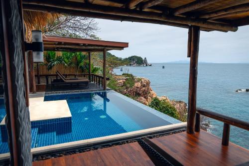 a view of the ocean from the deck of a villa at View Point Resort in Koh Tao