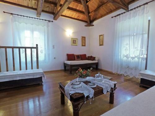 a living room with a table and a couch at Klea's House Skopelos in Skopelos Town