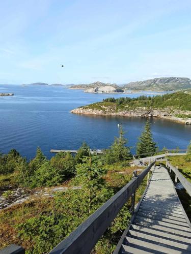 a view of a lake with a wooden bridge at Holiday home in Steinkjer in Steinkjer