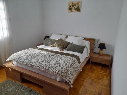 a bedroom with a large bed with two night stands at O Monteiriño in Arbo