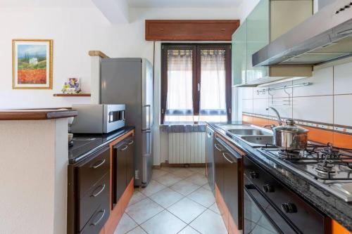 a kitchen with a sink and a stove top oven at Appartamento Confortevole, Wi-Fi & Colazione Free in Lanusei